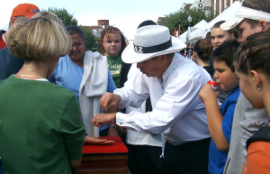 Magician Chaz does street magic for children at festival