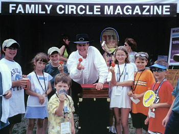 Magician Chaz Misenheimer entertains at a Family Circle Cup event